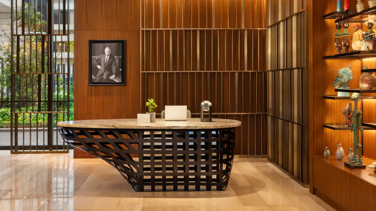 Custom metal wall panels and reception counter by NEXTOP in hotel lobby