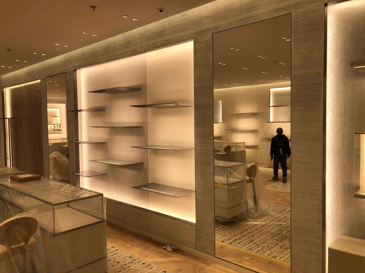 Bespoke metal retail display racks and shelving units by NEXTOP in a luxury brand shop