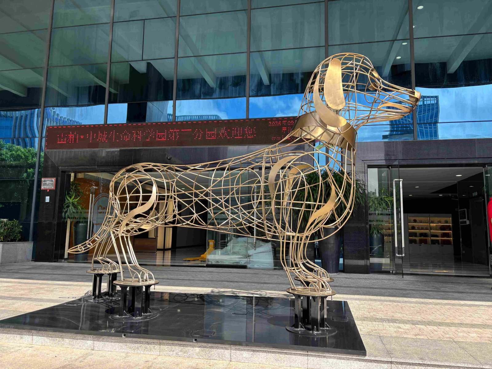 Finished dog-shaped metal sculpture by NEXTOP installed in a hospitality space